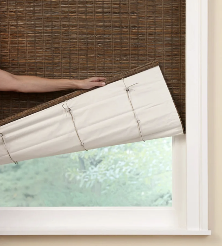 A natural woven shade with a liner on the back
