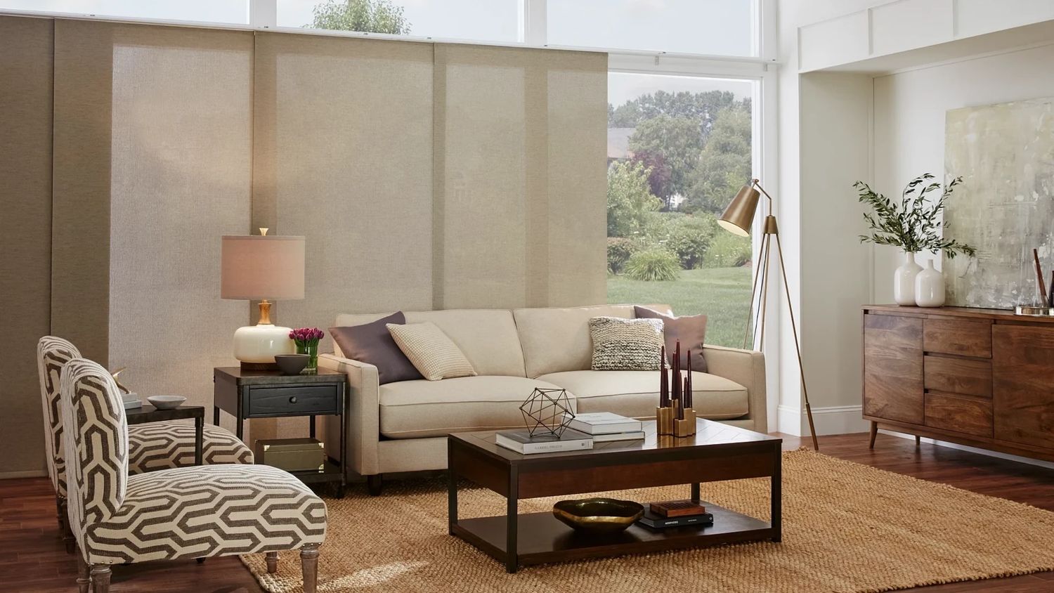 Light filtering Panel Track Shades across a living room window wall