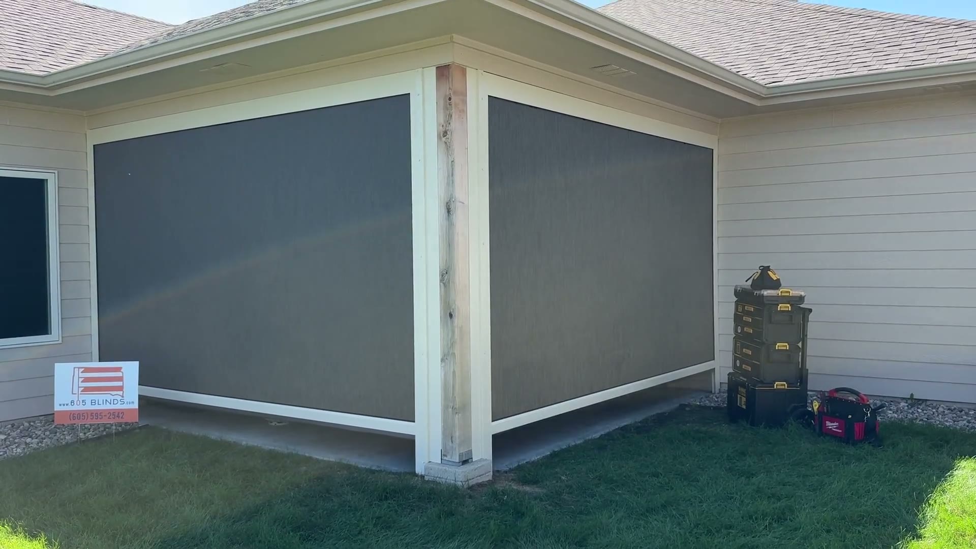 Dark Exterior Patio Shades lowered around a covered patio